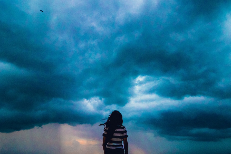 Woman facing oncoming storm