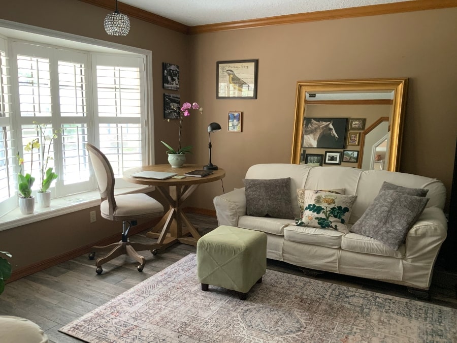 Home Office Retreat with round table, couch, oversized mirror