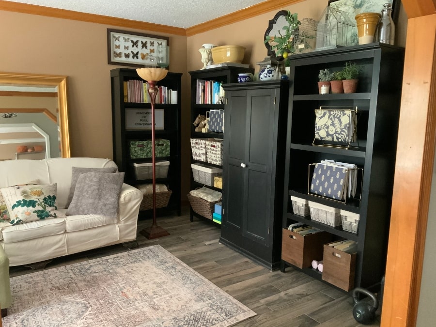 Home Office Retreat with view of shelving, couch, oversized mirror