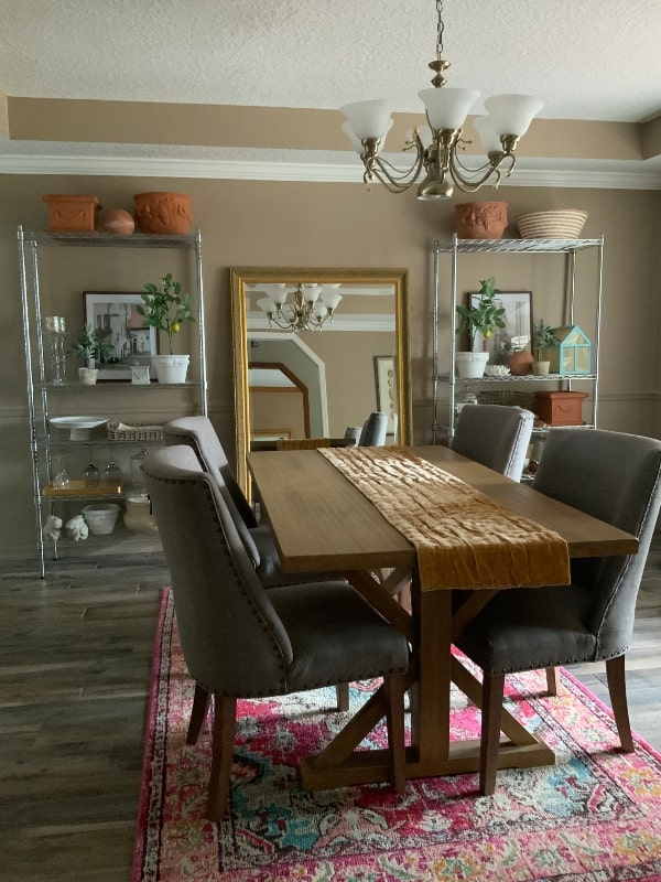 Dining Room with trestle table, oversized mirror, market shelving